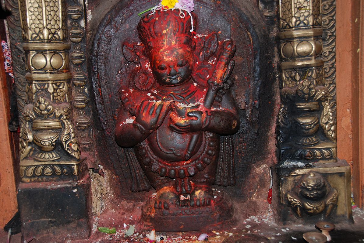 Kathmandu Patan Golden Temple 03 Mahakala In Entrance Doorway Mahakala, a deity worshipped by both Buddhists and Hindus, defends the dharma at the entrance to the Golden temple in Patan. Mahakala is of the eight terrible deities of the Buddhist pantheon, with snake ornaments, sharp teeth, protruding belly, and wearing a tiger skin.